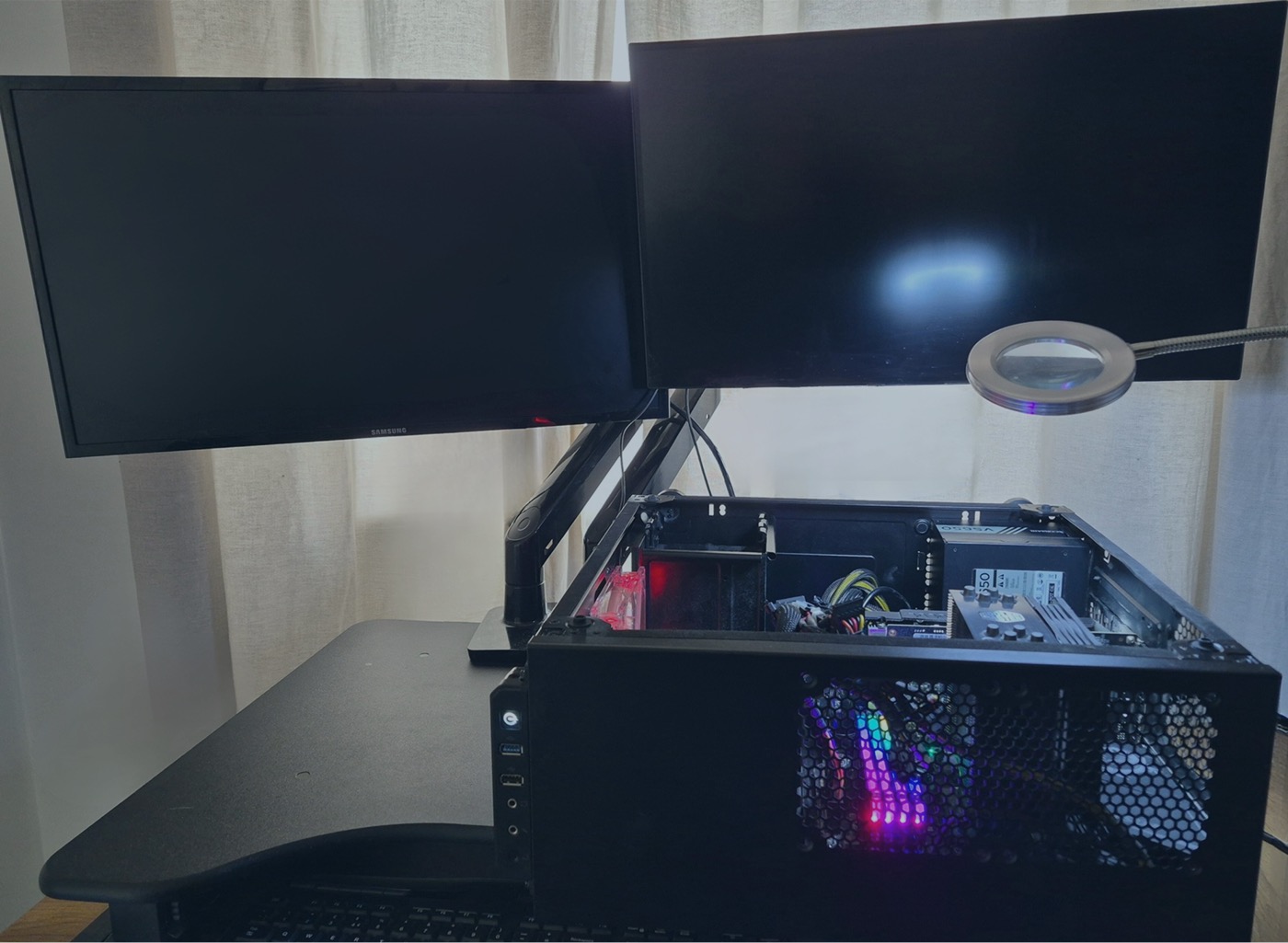 Nova computer repair workspace with monitors and an open desktop PC